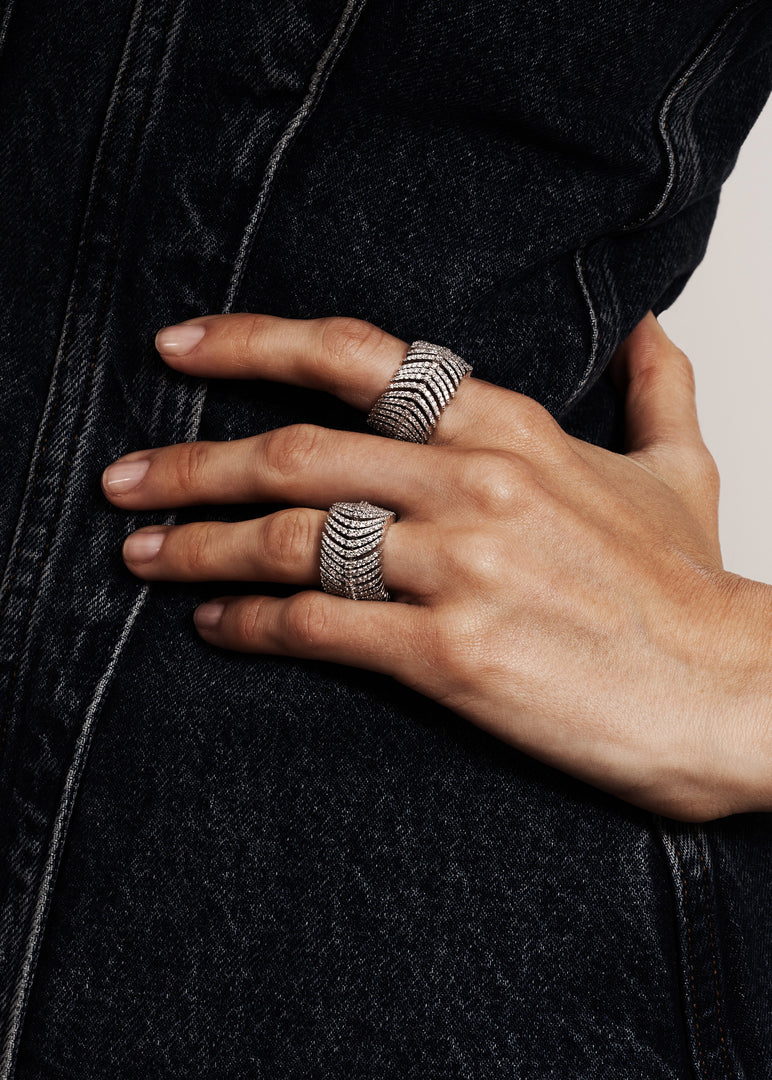 Art Deco Vivienne rings worn by model close up on hand on hip over denim top by Victoire