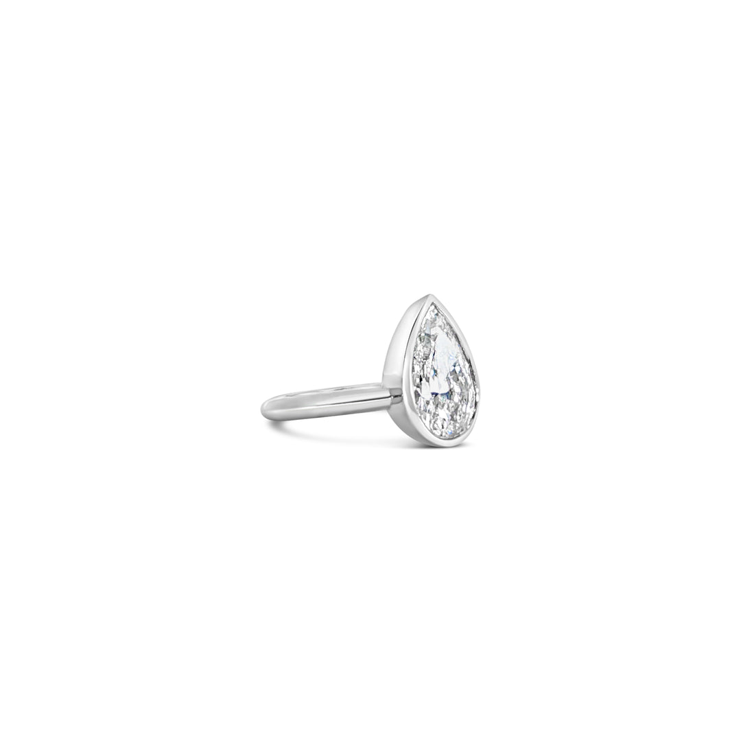 Detail of Les Pinky Collection pear lab grown diamond ring in bezel setting and platinum by Victoire