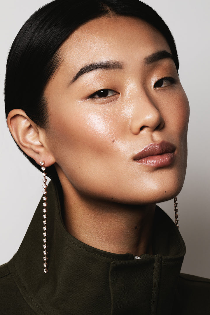 Model wearing Sequence collection tennis style long earrings with lab-grown diamonds on rose gold by Victoire